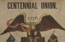 PATRIOTIC 1876 CENTENNIAL BANNER WITH AN EAGLE CARRYING THE LIBERTY BELL, SURROUNDED BY 13 STARS AND FLANKED BY PATRIOTIC PHRASES, WITH 38 STARS AROUND THE PERIMETER: