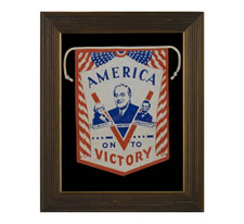 PATRIOTIC WINDOW BANNER WITH A PORTRAIT OF FRANKLIN DELANO ROOSEVELT SET INSIDE A "V-FOR-VICTORY", FLANKED BY GEORGE WASHINGTON AND ABRAHAM LINCOLN, MADE TO SUPPORT HIS RE-ELECTION IN 1944, A SCARCE CAMPAIGN TEXTILE FROM WWII