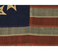 RARE AND BEAUTIFUL 13 STAR, CIVIL WAR PERIOD FLAG WITH A PERIMETER OF STARS THAT FORM THE LETTER "U" FOR "UNION".  ENTIRELY HAND-SEWN AND IN A RARE SMALL SIZE, 1861-65