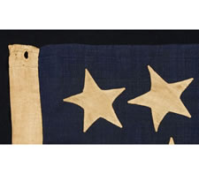 RARE AND BEAUTIFUL 13 STAR, CIVIL WAR PERIOD FLAG WITH A PERIMETER OF STARS THAT FORM THE LETTER "U" FOR "UNION".  ENTIRELY HAND-SEWN AND IN A RARE SMALL SIZE, 1861-65