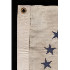 REVENUE CUTTER SERVICE ENSIGN WITH A BLUE EAGLE AMID AN ARCH OF 13 BLUE STARS, ON A WHITE FIELD, AND 16 VERTICAL RED AND WHITE STRIPES, CA 1890-1900