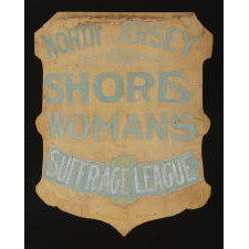 SHIELD-SHAPED BANNER FROM THE NORTH JERSEY SHORE WOMAN'S SUFFRAGE LEAGUE, HANDED DOWN THROUGH THE FAMILY OF ITS PRESIDENT, VIOLA AGUERO, WITH A LARGE ARCHIVE OF MATERIAL THAT INCLUDES AN IMAGE OF HER ACTUALLY HOLDING THE BANNER