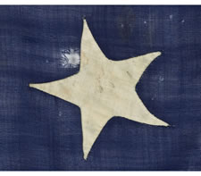 THE SMALLEST, SIGNED, ENTIRELY HANDSEWN 13 STAR FLAG THAT I HAVE EVER COME IN CONTACT WITH, MADE BY LAMPRELL & MARBLE, BOSTON, THE STARS ARRANGED IN AN OVAL VARIANT OF THE 3RD MARYLAND PATTERN, CIVIL WAR PERIOD (1861-65), EXTRAORDINARY AMONG KNOWN EXAMPLE