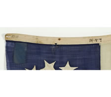 THE SMALLEST, SIGNED, ENTIRELY HANDSEWN 13 STAR FLAG THAT I HAVE EVER COME IN CONTACT WITH, MADE BY LAMPRELL & MARBLE, BOSTON, THE STARS ARRANGED IN AN OVAL VARIANT OF THE 3RD MARYLAND PATTERN, CIVIL WAR PERIOD (1861-65), EXTRAORDINARY AMONG KNOWN EXAMPLE