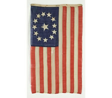 THE SMALLEST, SIGNED, ENTIRELY HANDSEWN 13 STAR FLAG THAT I HAVE EVER COME IN CONTACT WITH, MADE BY LAMPRELL & MARBLE, BOSTON, THE STARS ARRANGED IN AN OVAL VARIANT OF THE 3RD MARYLAND PATTERN, CIVIL WAR PERIOD (1861-65), EXTRAORDINARY AMONG KNOWN EXAMPLE