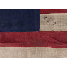 SPECTACULAR ANTIQUE AMERICAN FLAG WITH 31 STARS ARRANGED IN THE "GREAT STAR" PATTERN; ITS CANTON RESTING THE WAR STRIPE, 1850- 1858, CALIFORNIA STATEHOOD