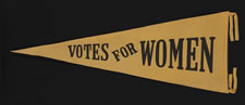 TRIANGULAR FELT SUFFRAGETTE PENNANT WITH PRINTED TEXT THAT READS:  "VOTES FOR WOMEN", CA 1910-1920