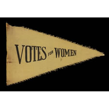 TRIANGULAR SUFFRAGETTE PENNANT WITH A CRUDE, PULLED WORK FRINGE AND TEXT THAT READS:  "VOTES FOR WOMEN", 1910-1920