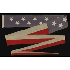 TWENTY-FOOT U.S. NAVY COMMISSIONING PENNANT WITH 13 STARS IN A TWO ROW ARRANGEMENT ON A DUSTY BLUE CANTON, WITH A PRESENTATION INSCRIPTION, 1876 - 1892