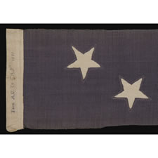 TWENTY-FOOT U.S. NAVY COMMISSIONING PENNANT WITH 13 STARS IN A TWO ROW ARRANGEMENT ON A DUSTY BLUE CANTON, WITH A PRESENTATION INSCRIPTION, 1876 - 1892