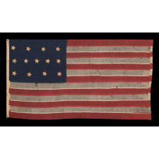 U.S. NAVY SMALL BOAT ENSIGN WITH 13 STARS IN THE 4-5-4 PATTERN, A VERY EARLY EXAMPLE, MADE circa 1835-1850’s, ENTIRELY HAND-SEWN AND IN A TINY SCALE AMONG ITS COUNTERPARTS