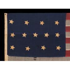 U.S. NAVY SMALL BOAT ENSIGN WITH 13 STARS IN THE 4-5-4 PATTERN, A VERY EARLY EXAMPLE, MADE circa 1835-1850’s, ENTIRELY HAND-SEWN AND IN A TINY SCALE AMONG ITS COUNTERPARTS