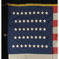 UNITED STATES INFANTRY BATTLE FLAG WITH A RARE ARRANGEMENT OF 42 STARS, AN UNOFFICIAL STAR COUNT, LATE INDIAN WARS PERIOD, WASHINGTON STATEHOOD, 1889-90