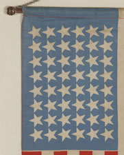 UNUSUAL WWI PERIOD WINDOW BANNER WITH 48 STARS ON A CORNFLOWER BLUE CANTON AND SILVER BULLION FRINGE, 1917-18