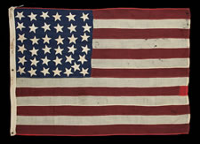 A WHIMSICAL ARRANGEMENT OF 37 STARS, POINTING IN VARIOUS DIRECTIONS, ON A FLAG WITH SMALLER THAN USUAL DIMENSIONS FOR THE PERIOD, 1867-1876, NEBRASKA STATEHOOD