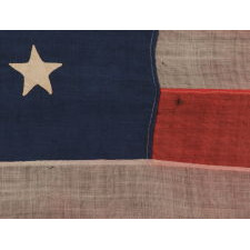 WOOL, CIVIL WAR, UNION INFANTRY BATTLE FLAG WITH 34 STARS AND EXCEPTIONAL PRESENTATION FROM HAVING BEEN EXTENSIVELY CARRIED, ACCOMPANIED BY ITS ORIGINAL STAFF, 1861-1863