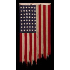 AMERICAN FLAG, 48 STARS, A U.S. NAVY SMALL BOAT ENSIGN, MADE IN SEPTEMBER OF 1943, DURING WWII, AT MARE ISLAND, CALIFORNIA, HEADQUARTERS OF THE PACIFIC FLEET, WITH ENDEARING WEAR FROM OBVIOUS LONG-TERM USE