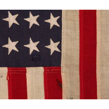 AMERICAN FLAG, 48 STARS, A U.S. NAVY SMALL BOAT ENSIGN, MADE IN SEPTEMBER OF 1943, DURING WWII, AT MARE ISLAND, CALIFORNIA, HEADQUARTERS OF THE PACIFIC FLEET, WITH ENDEARING WEAR FROM OBVIOUS LONG-TERM USE