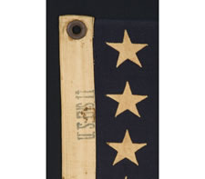 WWII BATTLE FLAG FROM THE U.S.S. FLINT WITH 48 STARS, BROUGHT HOME BY FIREMAN 2ND CLASS F. W. PERRINE, EMBROIDERED WITH HIS NAME, THE SHIP'S NAME, AND DATES OF SERVICE