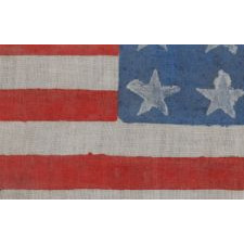 WWII PERIOD HOMEMADE PARADE FLAG WITH 20 STARS, 15 STRIPES THAT START AND END ON WHITE, AND A CANDY CANE STRIPED STAFF, MADE TO WELCOME U.S. SOLDIERS AFTER LIBERATION FROM GERMAN OCCUPATION, FOUND IN CHARTRES, FRANCE, ca 1944