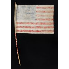 WWII PERIOD HOMEMADE PARADE FLAG WITH 20 STARS, 15 STRIPES THAT START AND END ON WHITE, AND A CANDY CANE STRIPED STAFF, MADE TO WELCOME U.S. SOLDIERS AFTER LIBERATION FROM GERMAN OCCUPATION, FOUND IN CHARTRES, FRANCE, ca 1944