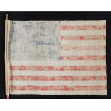 WWII PERIOD HOMEMADE PARADE FLAG WITH 20 STARS, 15 STRIPES THAT START AND END ON WHITE, AND A CANDY CANE STRIPED STAFF, MADE TO WELCOME U.S. SOLDIERS AFTER LIBERATION FROM GERMAN OCCUPATION, FOUND IN CHARTRES, FRANCE, ca 1944