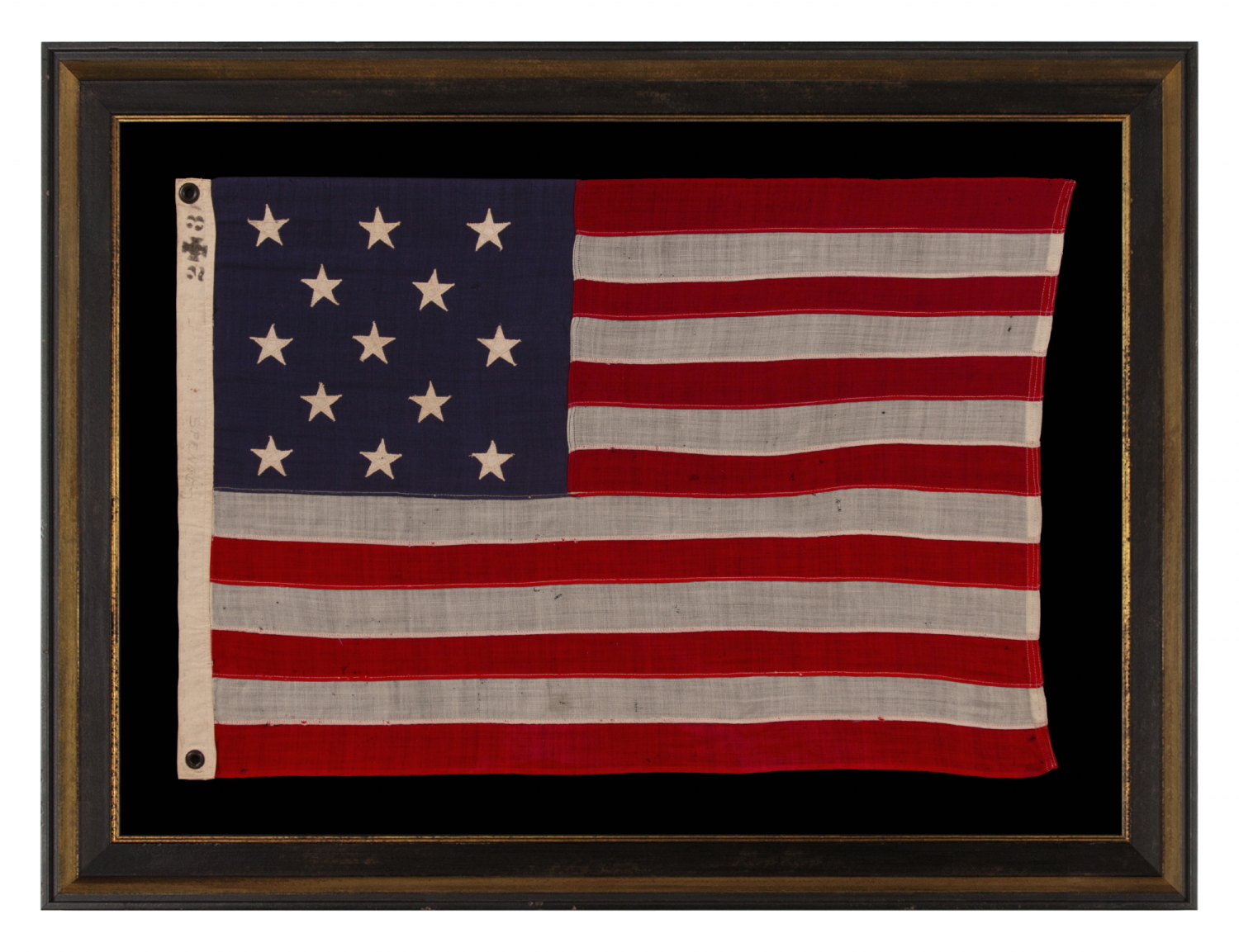 13 STAR ANTIQUE AMERICAN FLAG WITH A 3-2-3-2-3 CONFIGURATION OF STARS ON AN ATTRACTIVE, INDIGO BLUE CANTON; A SMALL-SCALE EXAMPLE OF THE 1895-1926 ERA, INSCRIBED WITH THE SURNAME “SPENGE,” LIKELY PRODUCED BY A MAKER WITH LINKS TO THE U.S. ARMY’S 19th CORPS