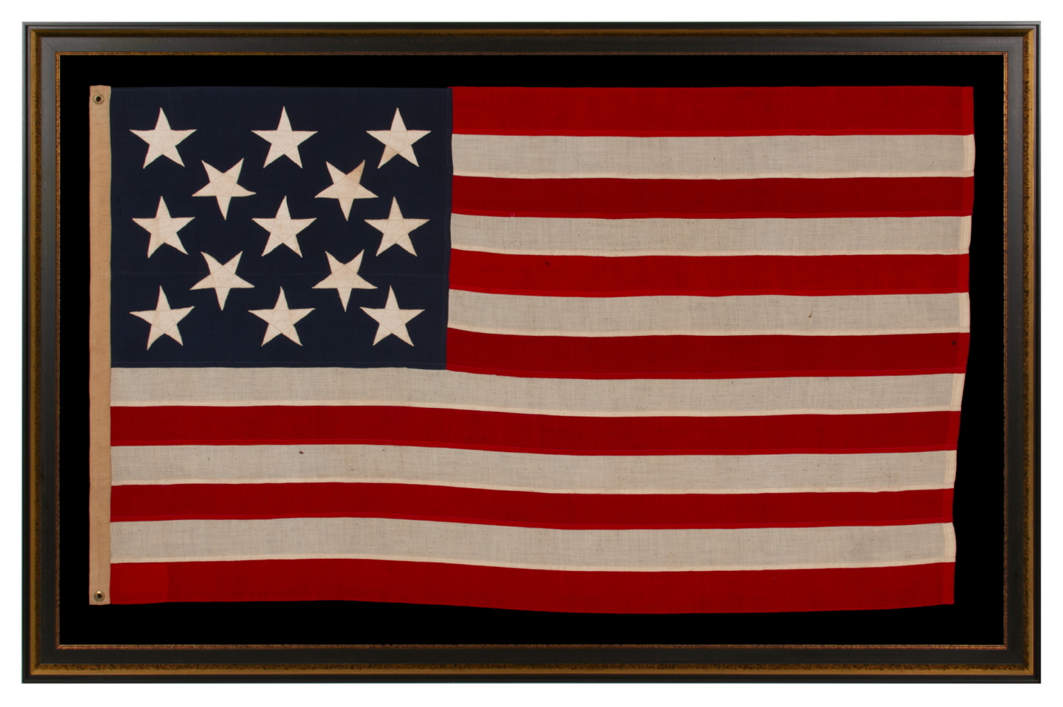 13 STAR ANTIQUE AMERICAN FLAG WITH A 3-2-3-2-3 PATTERN OF ESPECIALLY LARGE STARS; A U.S. NAVY SMALL BOAT ENSIGN, ALMOST CERTAINLY MADE AT MARE ISLAND, CALIFORNIA, circa 1906-1912, LARGER THAN THE SPECIFIED DIMENSIONS & UNCHARACTERISTICALLY UNSIGNED; EXTREMELY RARE