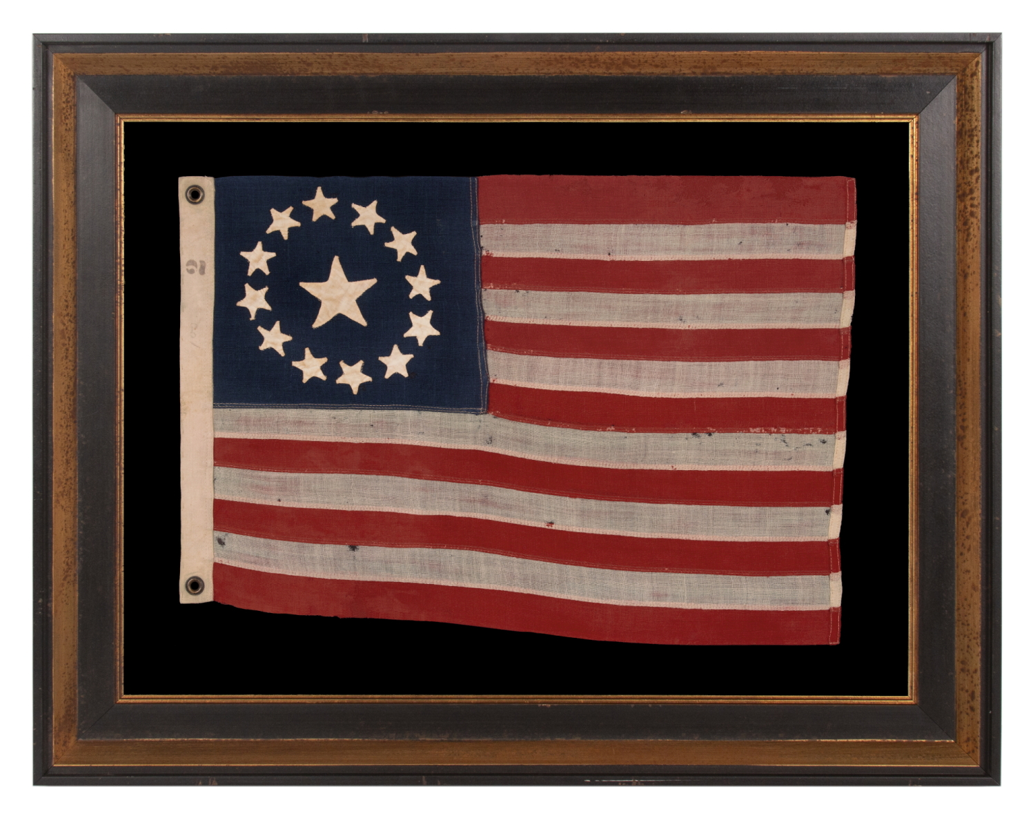 13 STAR ANTIQUE AMERICAN FLAG, IN A TINY SCALE AMONG PIECED-AND-SEWN EXAMPLES OF THE 19TH CENTURY, WITH HAND-SEWN STARS ARRANGED IN A CIRCULAR VERSION OF WHAT IS KNOWN AS THE 3RD MARYLAND PATTERN; FEATURES AN ESPECIALLY LARGE CENTER STAR, MADE circa 1885-1895