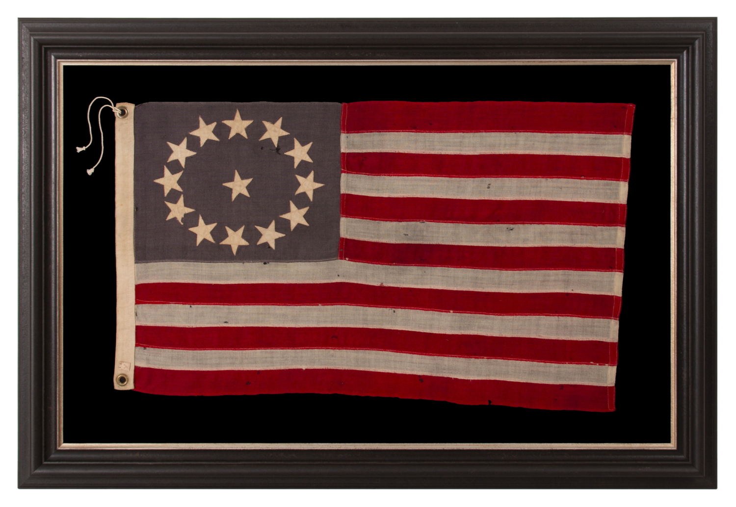13 STARS ON A DUSTY BLUE CANTON, IN AN OVAL VERSION OF WHAT IS KNOWN AS THE 3RD MARYLAND PATTERN, MADE DURING THE LAST DECADE OF THE 19TH CENTURY, MARKED WITH THE SURNAME “NYE”