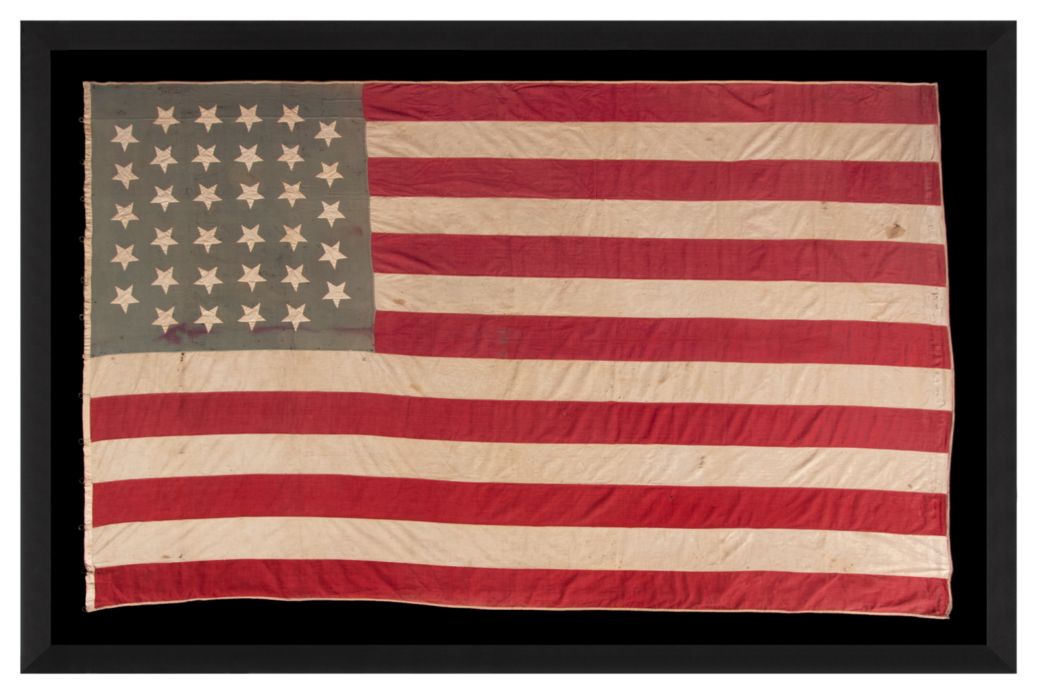 34 HAND-SEWN, UPSIDE-DOWN STARS ON A HOMEMADE, ANTIQUE AMERICAN FLAG WITH A VARIANT OF WHAT I HAVE CLASSIFIED AS A “GLOBAL” PATTERN, ON AN INTERESTING, SEAFOAM BLUE CANTON; REFLECTS KANSAS STATEHOOD, OPENING TWO YEARS OF THE CIVIL WAR, 1861-1863