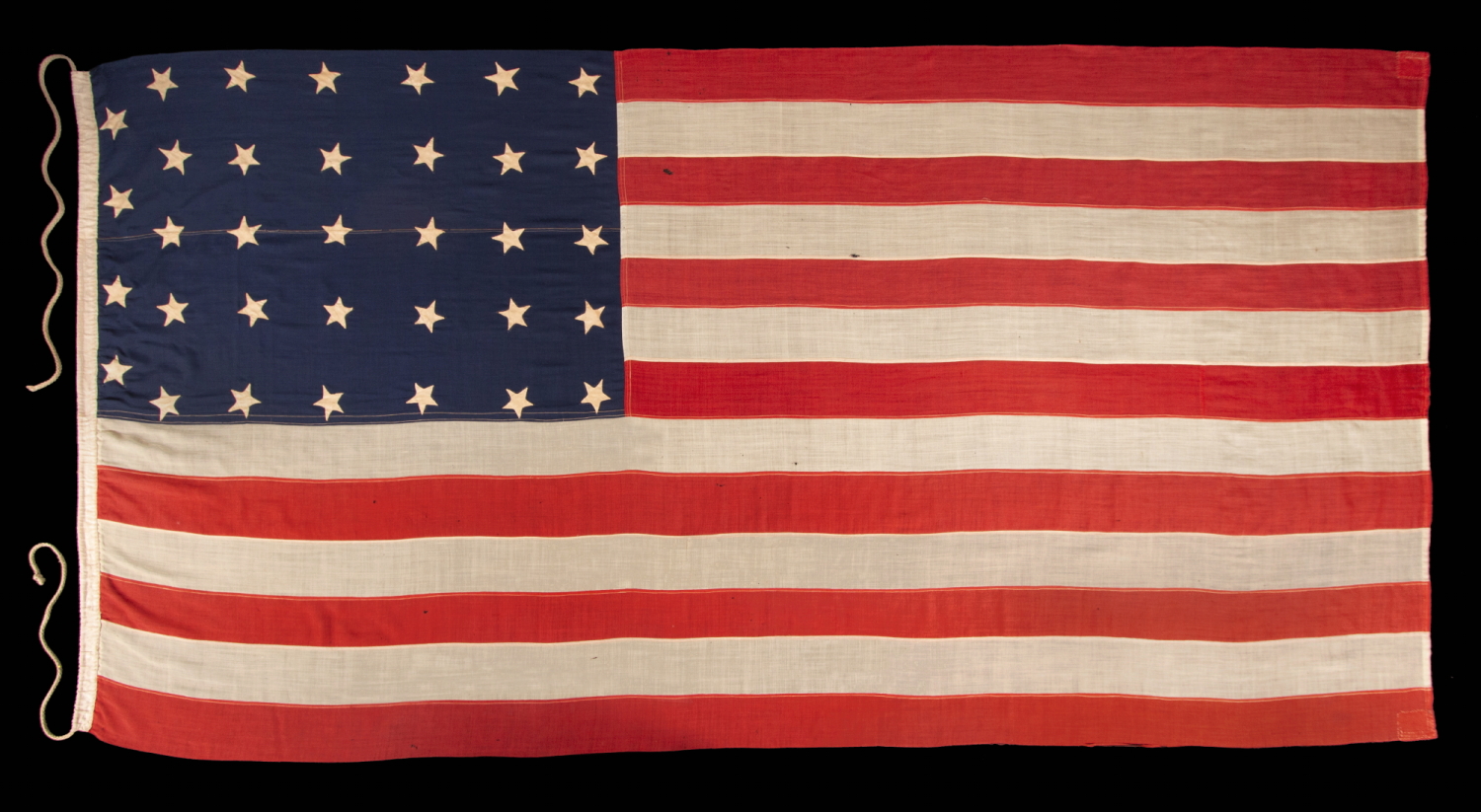 34 STAR ANTIQUE AMERICAN FLAG, ONE OF JUST TWO U.S. NAVY ENSIGNS I HAVE ENCOUNTERED WITH THE BLACK-INKED STENCIL “N.Y. B.” FOR ‘NAVY YARD, BROOKLYN,’ DATED “1859,” TWO YEARS BEFORE KANSAS WAS ADMITTED AS THE 34TH STATE; MARKED WITH THE NAME OF SAMUEL B. CHILDS, A NEW YORK PHYSICIAN WHO CLERKED FOR THE NAVY, AND SON OF A CAREER NAVAL OFFICER, JAMES CHILDS, WHO SERVED FOR 60 YEARS AS A SAILMAKER (1822-1881)