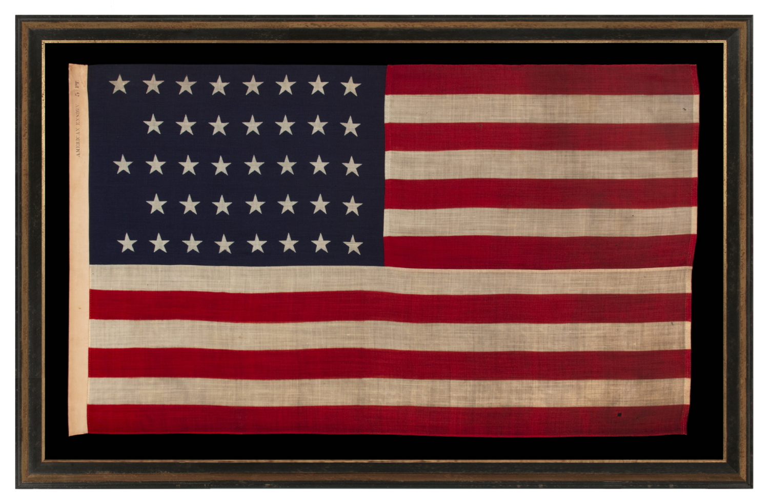 38 STAR ANTIQUE AMERICAN FLAG WITH A NOTCHED CONFIGURATION, MADE BY THE U.S. BUNTING COMPANY IN LOWELL, MASSACHUSETTS, REFLECTS THE ERA OF COLORADO STATEHOOD, circa 1876-1889