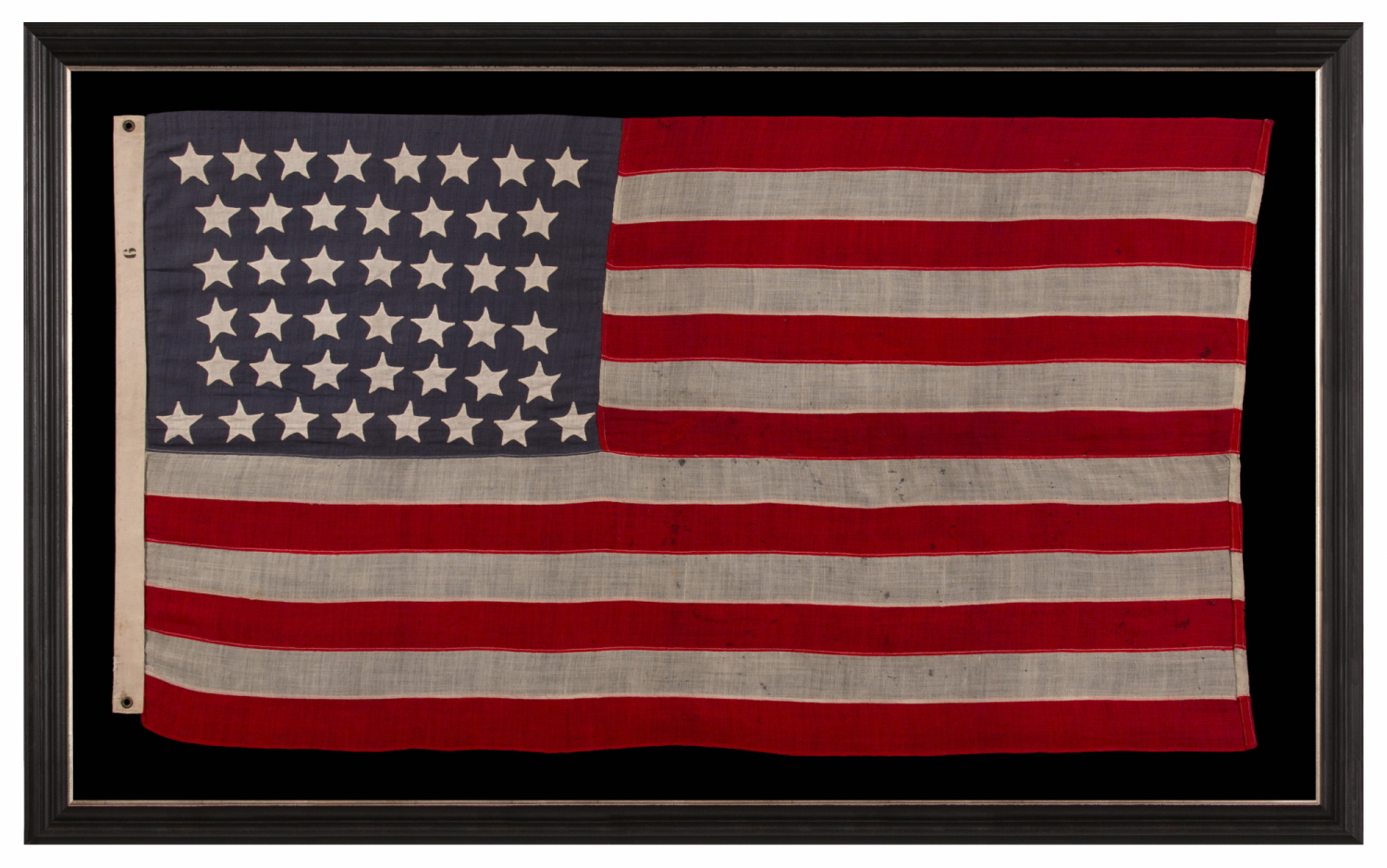 44 STAR ANTIQUE AMERICAN FLAG WITH AN HOURGLASS ARRANGEMENT ON A DUSTY BLUE CANTON; REFLECTS THE ERA WHEN WYOMING WAS THE MOST RECENT STATE TO JOIN THE UNION, 1890-1896