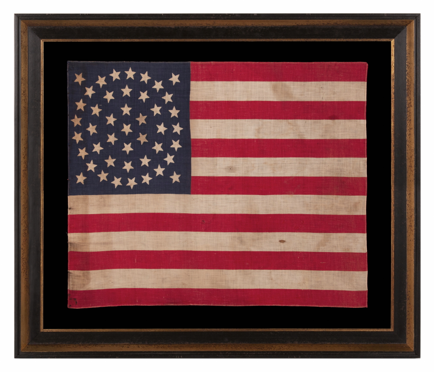 44 STAR ANTIQUE AMERICAN PARADE FLAG WITH A TRIPLE WREATH FORM OF THE MEDALLION CONFIGURATION, RARE IN THIS PERIOD WITH A CIRCULAR STAR ARRANGEMENT, 1890-1896, REFLECTS THE ADDITION OF WYOMING TO THE UNION