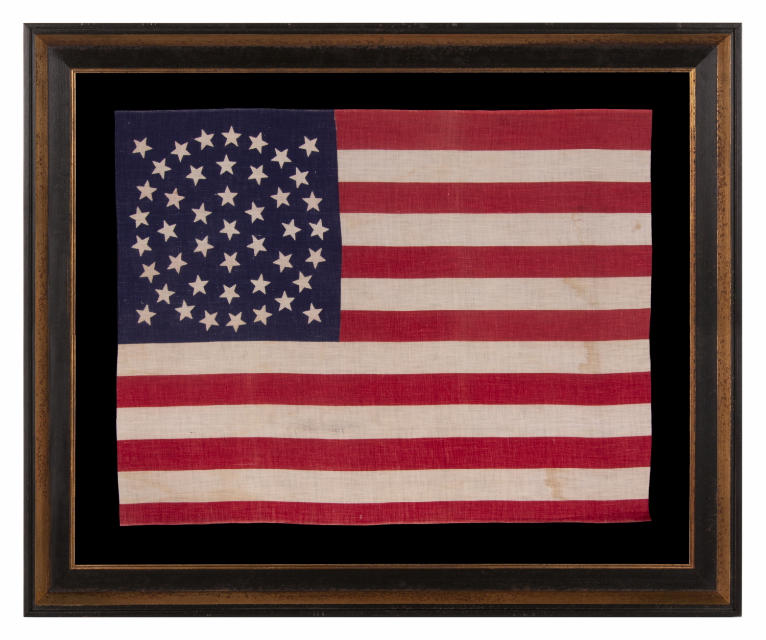 44 STAR ANTIQUE AMERICAN PARADE FLAG WITH A TRIPLE WREATH FORM OF THE MEDALLION CONFIGURATION, RARE IN THIS PERIOD WITH A CIRCULAR STAR ARRANGEMENT, 1890-1896, REFLECTS THE ADDITION OF WYOMING TO THE UNION