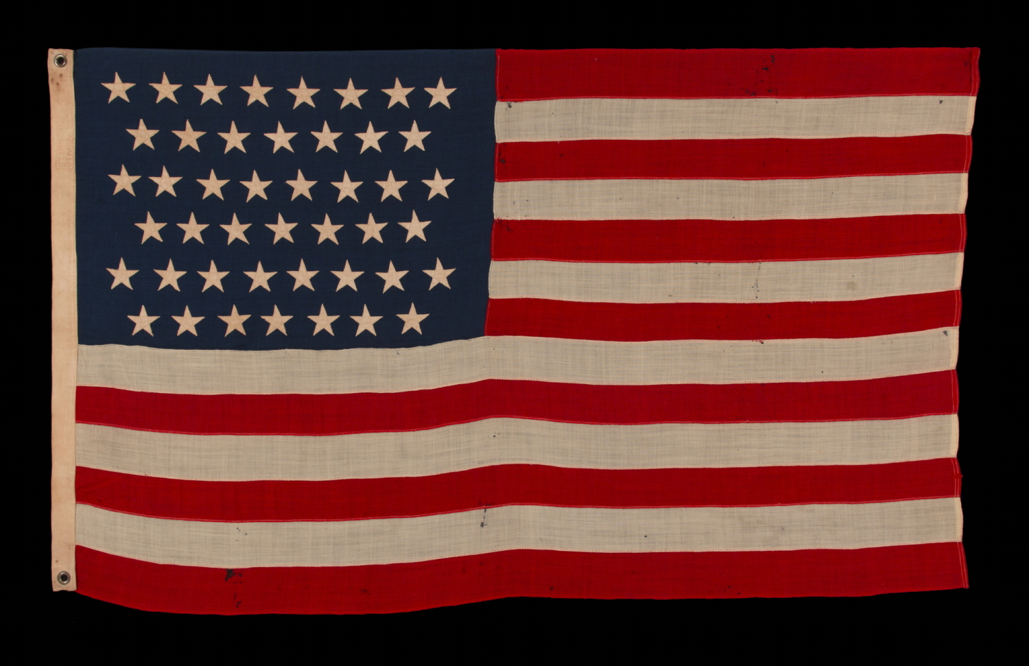 45 STAR ANTIQUE AMERICAN FLAG IN A SMALL AND DESIRABLE SCALE AMONG THOSE OF THE PERIOD WITH PIECED AND SEWN CONSTRUCTION, OFFICIAL FROM 1896-1908; MARKED ‘STANDARD”; SPANISH-AMERICAN WAR ERA, REFLECTS THE PERIOD WHEN UTAH WAS THE MOST RECENT STATE TO JOIN THE UNION