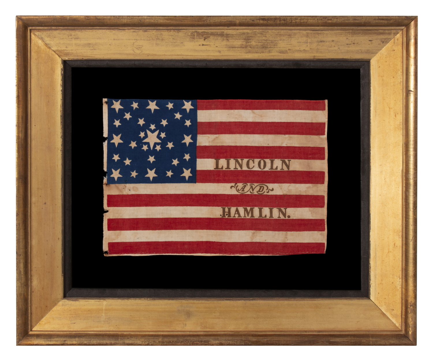 ANTIQUE AMERICAN FLAG MADE FOR THE 1860 PRESIDENTIAL CAMPAIGN OF ABRAHAM LINCOLN & HANNIBAL HAMLIN, WITH 31 STARS IN A FANCIFUL STARBURST OR ‘GREAT STAR-IN-A-SQUARE’ MEDALLION; ONE OF THE RAREST AND MOST GRAPHIC OF ALL CONFIGURATIONS THAT HAVE BEEN IDENTIFIED IN 19TH CENTURY EXAMPLES; THE ONLY KNOWN LINCOLN CAMPAIGN FLAG IN THIS STYLE, AND ONE OF JUST 3 PARADE FLAGS OF ANY SORT THAT SHARE THIS SPECTACULAR STAR ARRANGEMENT