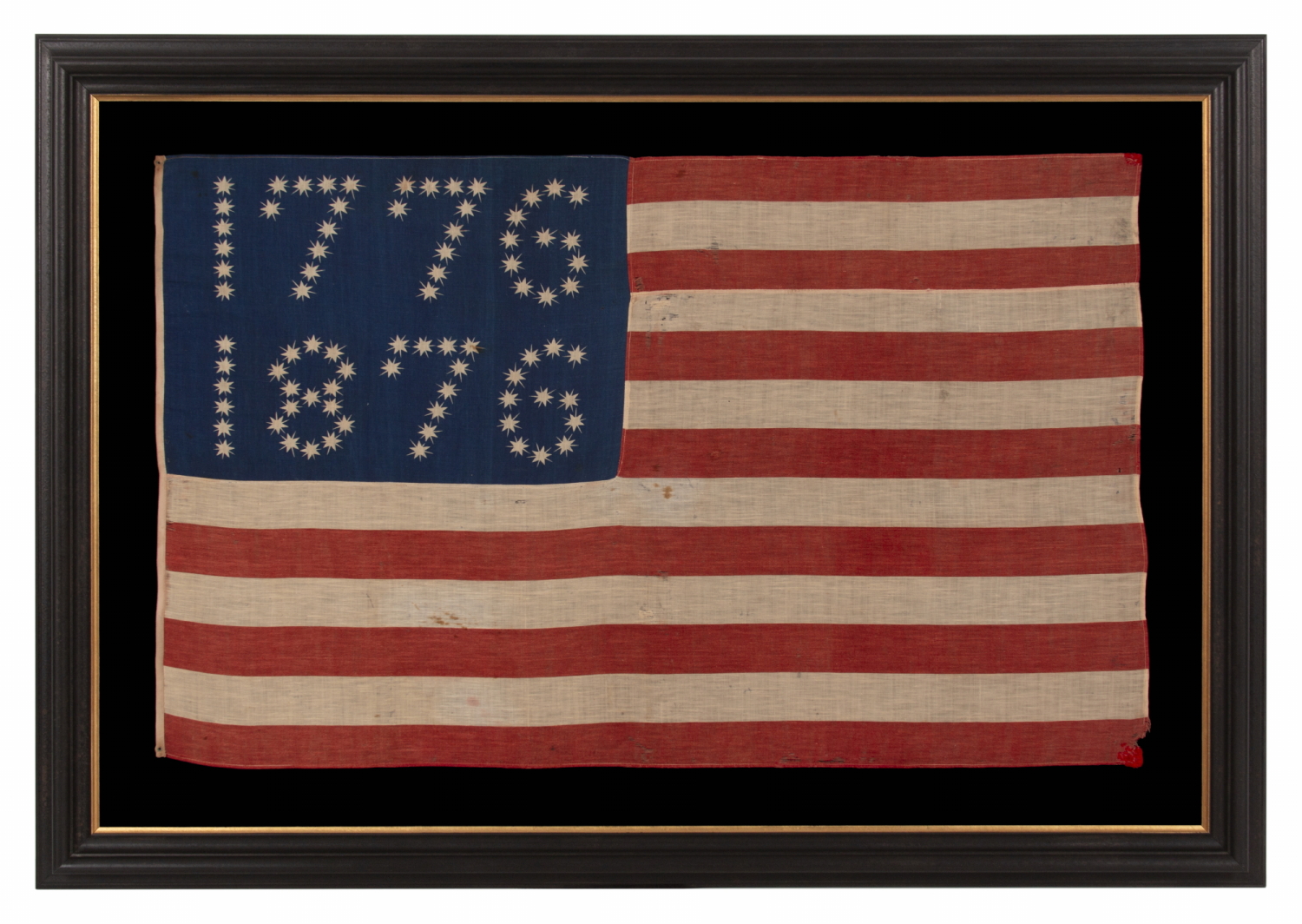 ANTIQUE AMERICAN FLAG WITH 10-POINTED STARS THAT SPELL “1776 – 1876”, MADE FOR THE 100-YEAR ANNIVERSARY OF AMERICAN INDEPENDENCE, ONE OF THE MOST GRAPHIC OF ALL EARLY EXAMPLES