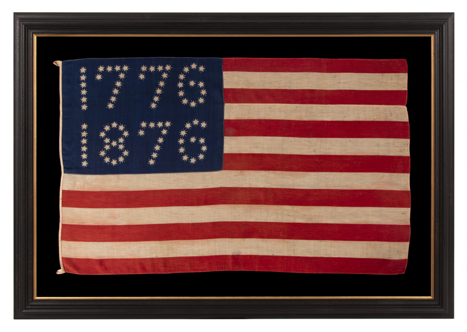 ANTIQUE AMERICAN FLAG WITH 10-POINTED STARS THAT SPELL “1776 – 1876”, MADE FOR THE 100-YEAR ANNIVERSARY OF AMERICAN INDEPENDENCE, ONE OF THE MOST GRAPHIC OF ALL EARLY EXAMPLES