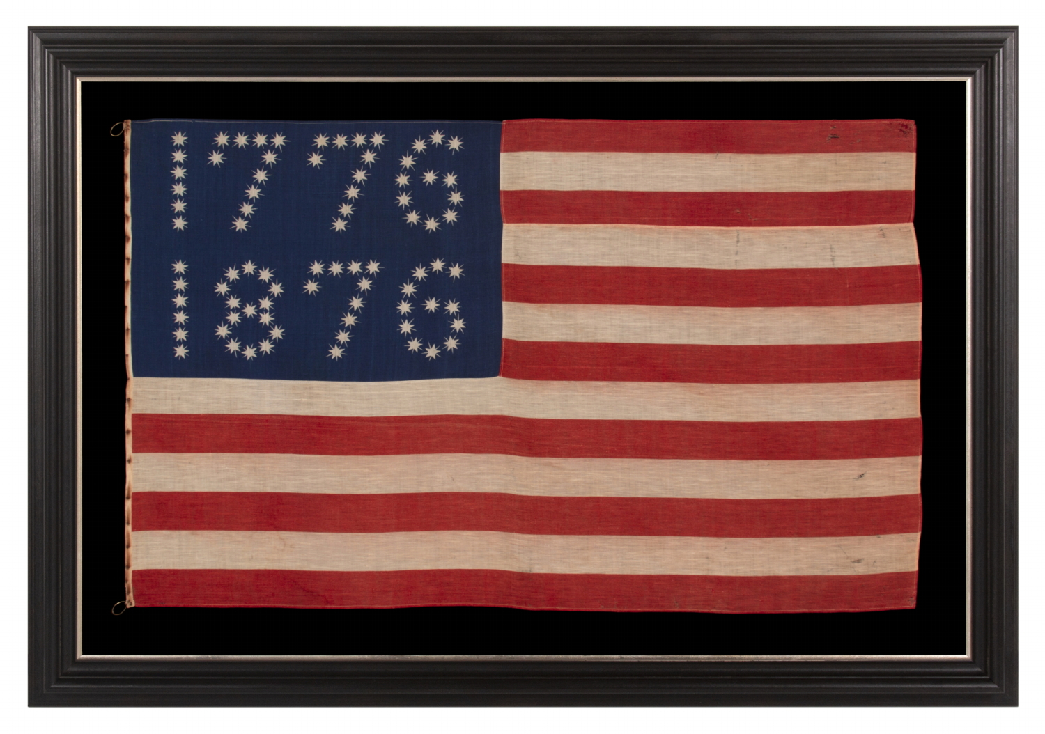 ANTIQUE AMERICAN FLAG WITH 10-POINTED STARS THAT SPELL “1776 – 1876”, MADE FOR THE 100-YEAR ANNIVERSARY OF AMERICAN INDEPENDENCE, ONE OF THE MOST GRAPHIC OF ALL EARLY EXAMPLES