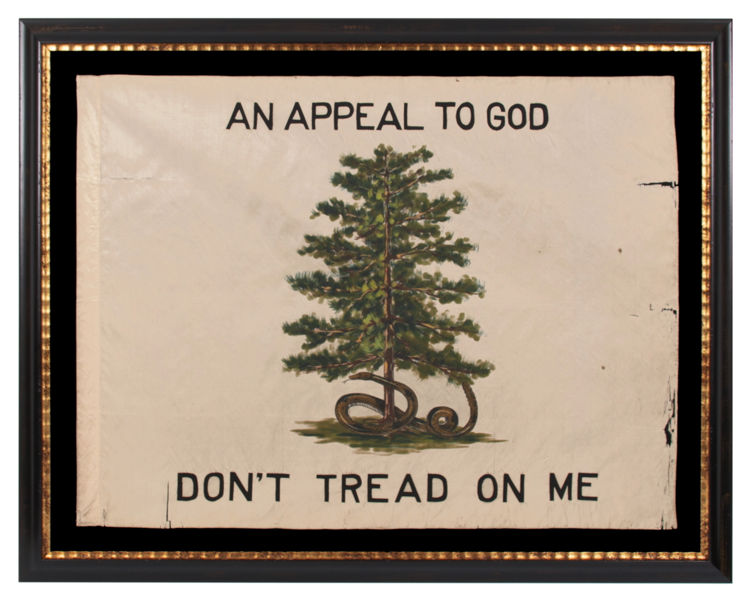 ONE OF THE ONLY ANTIQUE AMERICAN FLAGS I AM AWARE TO SURVIVE IN A DESIGN THAT INCLUDES A RATTLESNAKE, THIS EXAMPLE IN A VARIANT OF THOSE RECORDED IN USE BY THE COLONIAL MASSACHUSETTS NAVY FROM LATE 1775 - 1776, AND POSSIBLY BY THE PENNSYLVANIA NAVY ON THE DELAWARE RIVER BETWEEN LATE 1775 – 1778, ALL WITH A GREEN PINE TREE AS THE CENTRAL DEVICE UPON A WHITE FIELD; THIS EXAMPLE WITH A RATTLESNAKE COILED ABOUT ITS BASE AND ADORNED WITH “AN APPEAL TO GOD” & “DON’T TREAD ON ME” SLOGANS, H