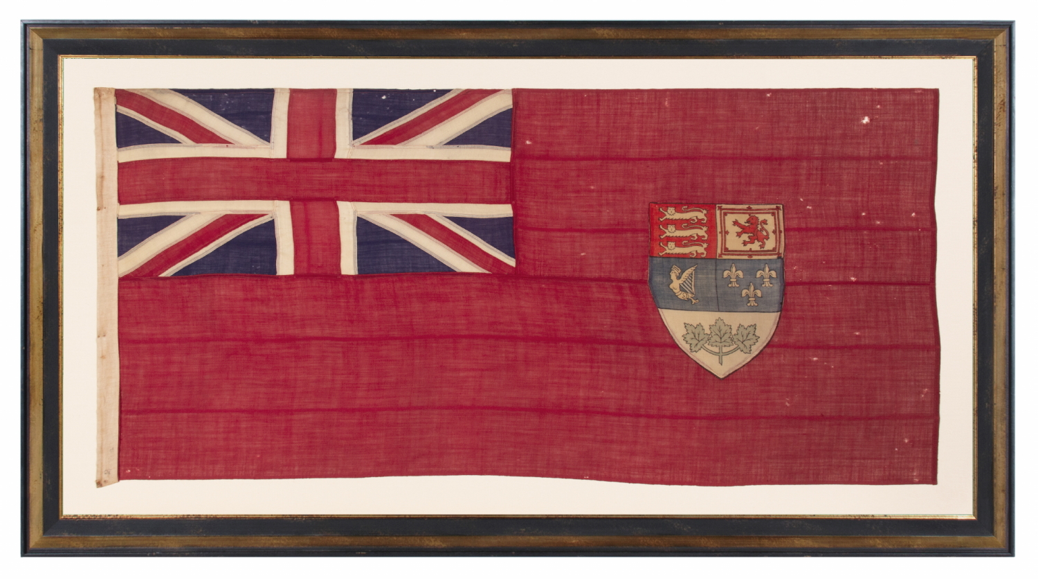 CANADIAN RED ENSIGN WITH THE ARMS OF CANADA, IN THE DESIGN ADOPTED IN 1922, IN USE UNTIL APPROXIMATELY 1957; THIS EXAMPLE LIKELY MADE circa 1920’s – 1940’s