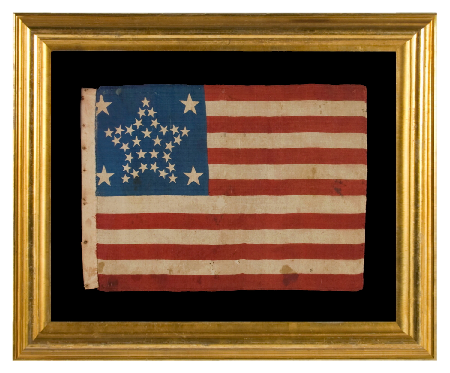 34 STARS IN A RARE “GREAT STAR” PATTERN THAT INCORPORATES HUGE CORNER STARS, ON AN ANTIQUE AMERICAN PARADE FLAG MADE DURING THE OPENING TWO YEARS OF THE CIVIL WAR, circa 1861-63; REFLECTS KANSAS STATEHOOD