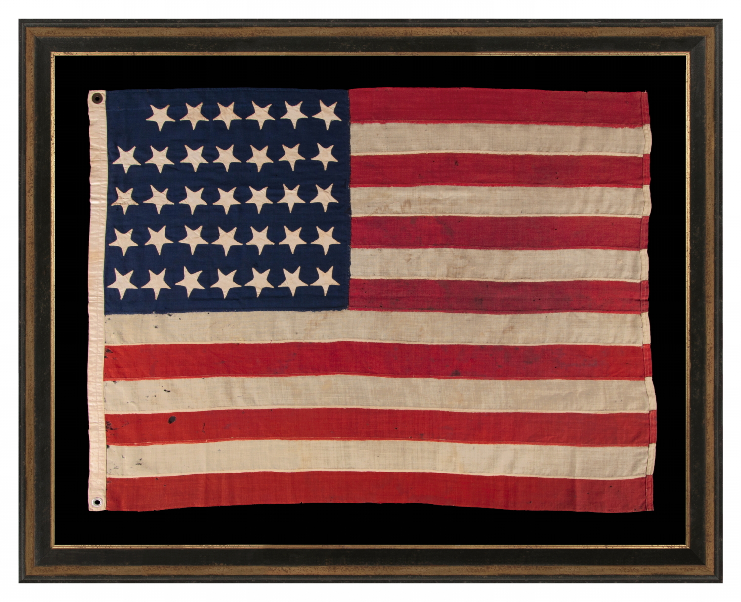34 UPSIDE-DOWN, HAND-SEWN STARS IN A NOTCHED CONFIGURATION, ON AN ANTIQUE AMERICAN FLAG OF THE CIVIL WAR PERIOD, WITH A SQUARISH PROFILE AND IN AN EXTREMELY SMALL SCALE AMONG ITS COUNTERPARTS; FOUND IN PENNSYLVANIA & RELATED TO ANOTHER FLAG FOUND IN THE RAFTERS OF A BARN IN PERRY COUNTY; REFLECTS THE ADDITION OF KANSAS AS THE 34TH STATE, circa 1861-1863
