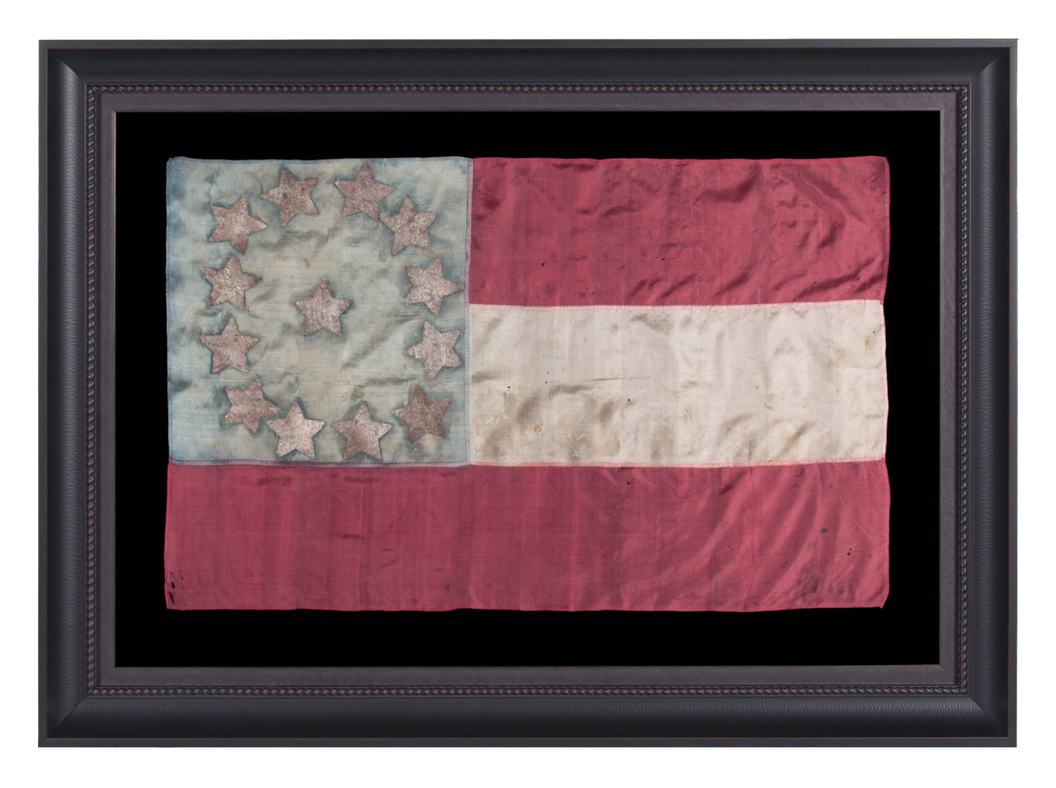 EXTRAORDINARY, HOMEMADE, 1ST CONFEDERATE NATIONAL FLAG, MADE OF LADIES’ DRESS SILK, WITH BEAUTIFUL COLORS AND EXCEPTIONAL PRESSED FOIL STARS, POSSIBLY OF NORTH CAROLINA ORIGIN; LIKELY PRESENTED TO AN OFFICER BY A LOVED ONE AND SEEMINGLY DISPLAYED THEREAFTER AS CONDITIONS PERMITTED; CAPTURED OR SEIZED BY CHAPLAIN-TURNED-GENERAL ELIPHALET WHITTLESEY OF MAINE, A STRONG OPPONENT OF SLAVERY, WHO EVENTUALLY LED AN ALL-BLACK REGIMENT (46TH U.S. COLORED TROOPS)