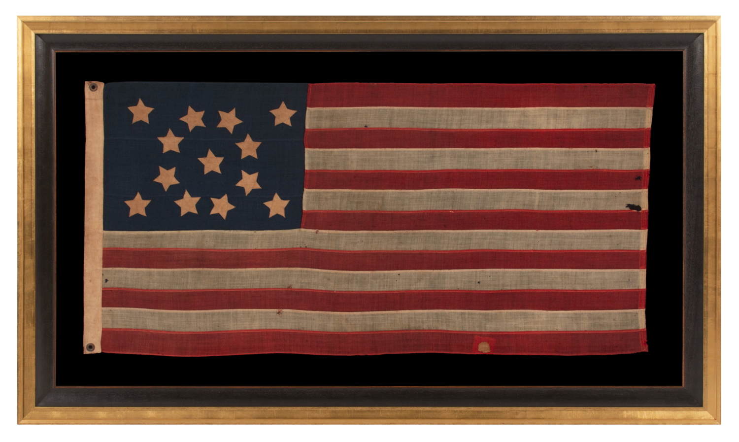 13 STARS WITH SHORT, CONICAL ARMS ON A SMALL SCALE, ANTIQUE AMERICAN FLAG WITH A BEAUTIFULLY ELONGATED FORMAT AND MUCH PATINA FROM OBVIOUS USE; MADE DURING THE LAST DECADE OF THE 19th CENTURY, POSSIBLY BY J.S. OBERHOLTZER IN GERMANTOWN [PHILADELPHIA], PENNSYLVANIA