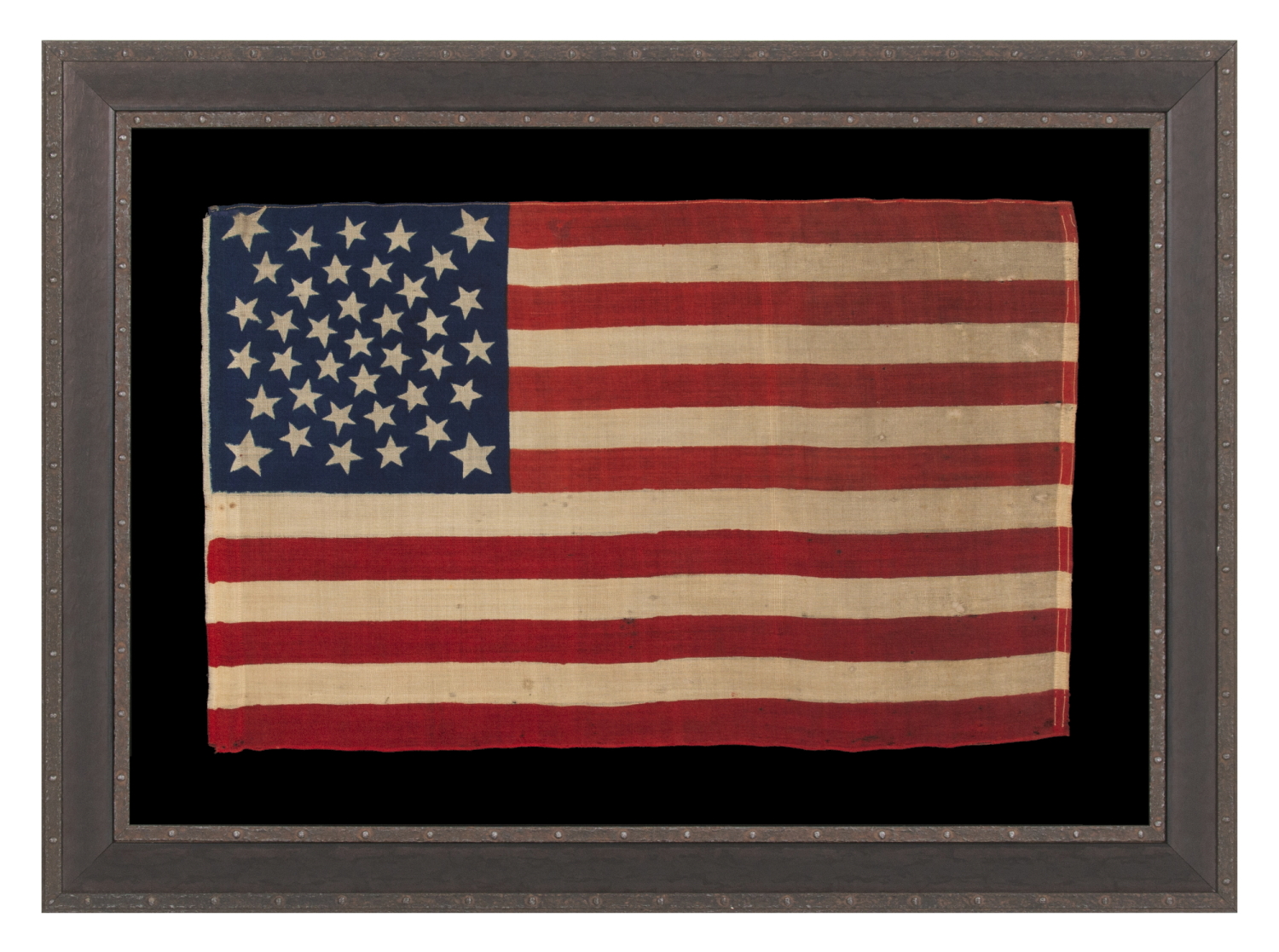 38 STARS, COLORADO STATEHOOD, A SCARCE AND BEAUTIFUL ANTIQUE AMERICAN FLAG WITH A MEDALLION PATTERN AND 4 LARGE CORNER STARS, PRESS-DYED ON WOOL BUNTING, MADE BY HORSTMANN BROTHERS IN PHILADELPHIA FOR THE 1876 CENTENNIAL OF OUR NATION’S INDEPENDENCE