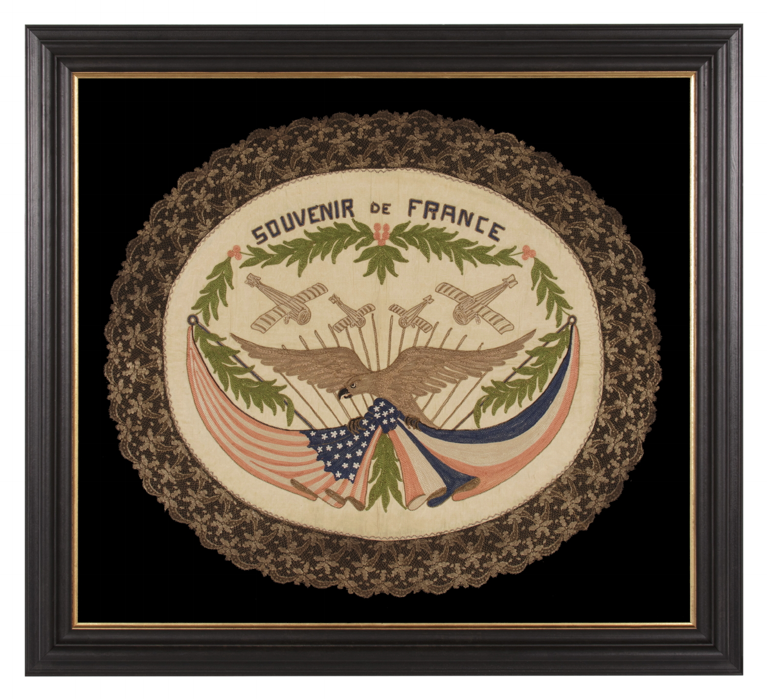 FRANCO-AMERICAN TEXTILE WITH THE IMAGE OF AN EAGLE SUPPORTING KNOTTED & DRAPED AMERICAN AND FRENCH FLAGS BENEATH FOUR WAR PLANES; EMBROIDERED SILK FLOSS AND METALLIC BULLION THREAD ON A SILK GROUND, WITH ELABORATE BULLION FRINGE, MADE TO CELEBRATE THE END OF WWI (U.S. INVOLVEMENT 1917-18)