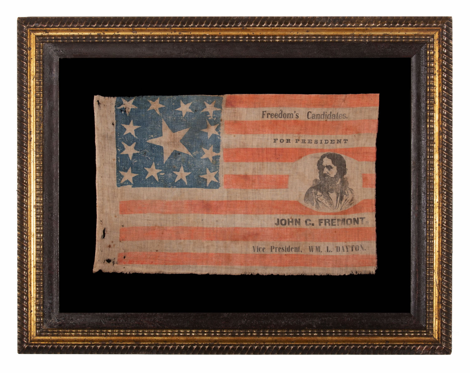 EXTRAORDINARILY RARE, PORTRAIT STYLE PARADE FLAG, MADE FOR THE PRESIDENTIAL CAMPAIGN OF JOHN FRÉMONT, WHO OPENED THE GATEWAY TO CALIFORNIA STATEHOOD, WAS THE REPUBLICAN PARTY’S FIRST PRESIDENTIAL CANDIDATE, AND RAN ON AN ANTI-SLAVERY PLATFORM; DISPLAYING 13 STARS, ARRANGED IN THE TRUMBULL PATTERN